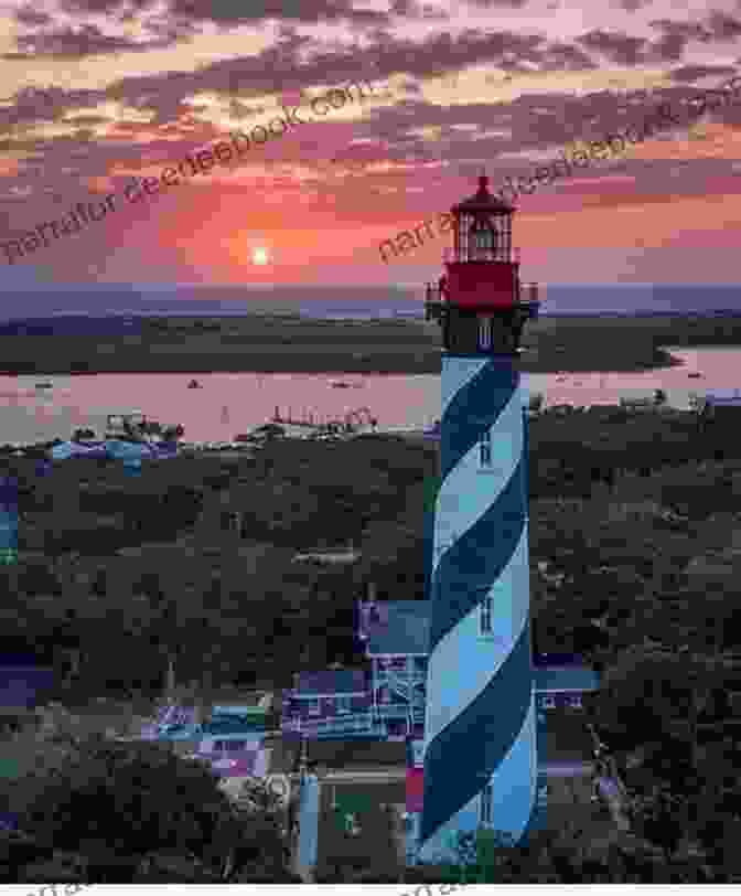 St. Augustine Lighthouse, Florida, Rises Majestically From The Lush Greenery Of Anastasia Island, Its Red Brick Exterior And White Trim Standing Out Against The Clear Blue Sky. 60 Lighthouses: Photographs By Kevin Woyce
